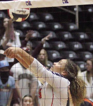 Kieryn Adams saves a ball at the net in the first set. Sticker Photo By Darrell Vyvjala