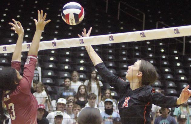 Meredith Magliolo tips the ball past a Lady Bulldog for a point in game three. Sticker Photo By Darrell Vyvjala