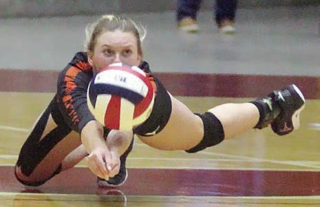 Avery Helms dives to get to an Iola attack in game four. Sticker Photo By Darrell Vyvjala
