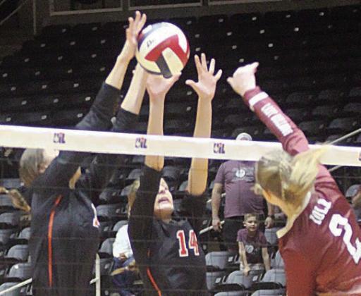 Meredith Magliolo (left) and Emmrie Marx team up for a block in the second set. Sticker Photo By Darrell Vyvjala