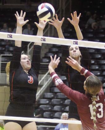 Reagan Dusek (left) and Meredith Magliolo go up for a block in game four. Sticker Photo By Darrell Vyvjala