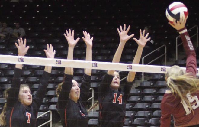 From left: Landry Zapalac, Brooke Redding, and Emmrie Marx go up to contest a Lindsey Gooch attack in game four. Sticker Photo By Darrell Vyvjala