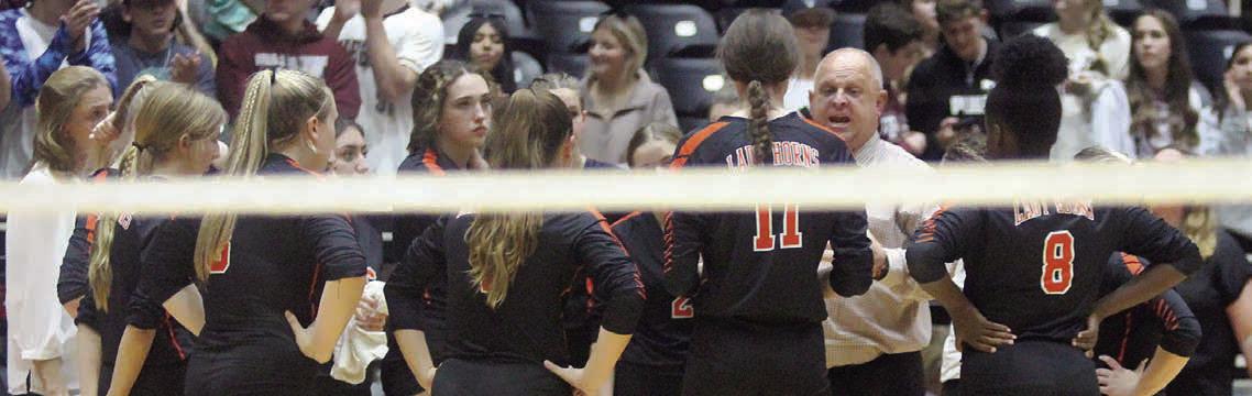 Head coach Donald Zapalac instructs his team during a timeout in the third set. Sticker Photo By Darrell Vyvjala