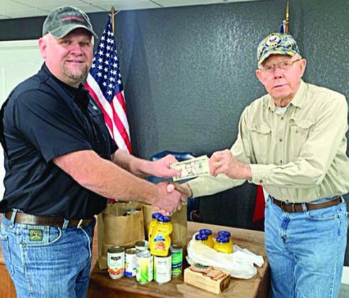 Paul Zapalac (left), Justice of the Peace of Precinct 4, hosted an open house at his office on Thursday, Dec. 19. Those attending were asked to make a donation to the Schulenburg Area Food Pantry. Zapalac is shown presenting the donations of 20 pounds of food and $55 cash to Ken Berger (right), SAFP volunteer. Thanks go to the Schulenburg community for their generosity.