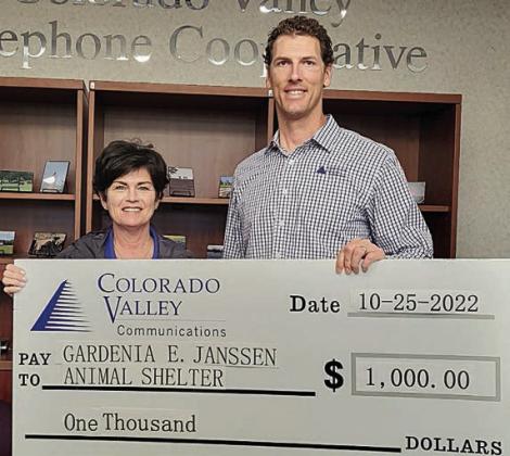 Members of Colorado Valley Telephone Cooperative gave donations to be presented to the Gardenia E. Janssen Animal Shelter. Shown are (from left) Teresa Stanley-Brown, director of the Gardenia E. Janssen Animal Shelter, and Kenn Kasparek, sales and marketing coordinator at Colorado Valley Telephone Cooperative.