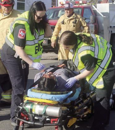 EMS personnel work on Yaritza Delgado before she had to be life-flighted. Sticker Photo By Darrell Vyvjala