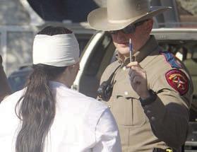 A DPS trooper gives Toree Bohlmann a field sobriety test. Sticker Photo By Darrell Vyvjala