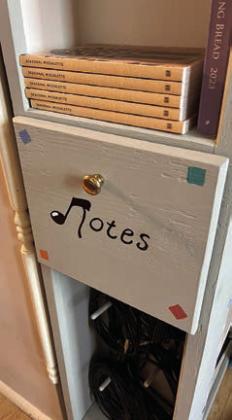 Buddy Hemann custombuilt a new cabinet for the choir at St. Mary’s Catholic Church in High Hill. The cabinet, located in the choir loft, is shown at left with the church altar in the background. A view of the other side of the cabinet appears in the center photo, and the right photo shows a closeup of the “Notes” compartment.