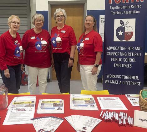 Shown BEHIND the table with materials about the Fayette County Retired Teachers Association are (from left) Karen Fitch, Chris Morrison, Peggy Halamicek and Lisa Slinkard.