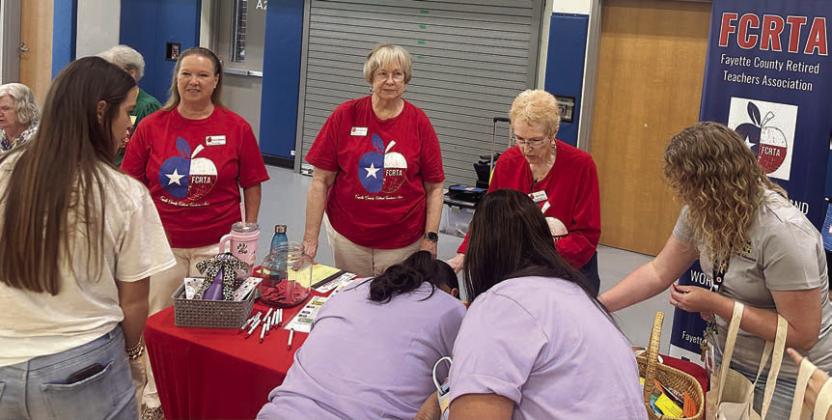 La Grange ISD pers onnel sign up for more information on FCRTA. Members assisting included (standing in back, from left) Lisa Slinkard, Chris Morrison and Karen Fitch.