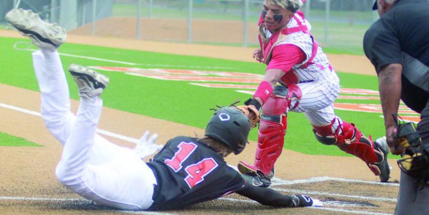 Connor Lichnovsky get his right hand to home plate ahead of the tag to score in the top of the first inning of game one. Sticker Photo By Darrell Vyvjala