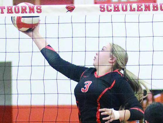 Reagan Dusek reaches to tip a ball over for a point in game one last Tuesday. Sticker Photo By Darrell Vyvjala