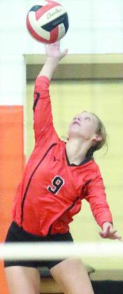 Michaela Kollmann, whose ace capped the win over Flatonia, serves in the first set. Sticker Photo By Darrell Vyvjala