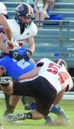 Tyson Wagner (No. 54) and John Davis bring down Cody Howard for a loss of 6 on Randolph’s first play from scrimmage. Sticker Photo By Darrell Vyvjala