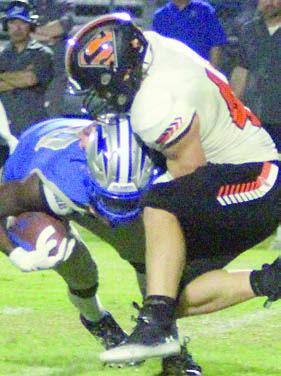 Jacob Vacek wrestles down Nate Skeete for a loss of 5 in the fourth quarter. Sticker Photo By Darrell Vyvjala