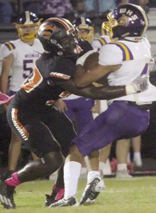 Rodney H Walton tackles Jerron Fisher for a loss of 2 in the first quarter. Sticker Photo By Layne Vyvjala