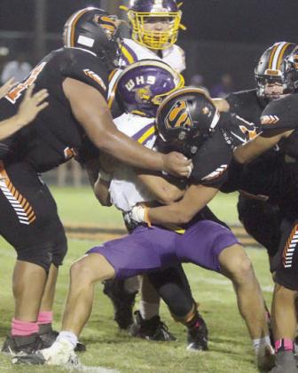 Calvin Thompson (left) and Aidan Mendez combine for a fourth-quarter stop. Sticker Photo By Darrell Vyvjala