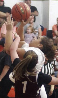 Arianna Vincent gets fouled by a Maiden on a shot in the lane in the third quarter. Sticker Photo By Darrell Vyvjala