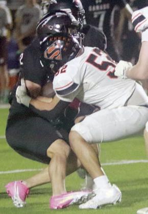 Max Hernandez tackles Logan Bures for a third-down stop in the third quarter. Sticker Photo By Darrell Vyvjala