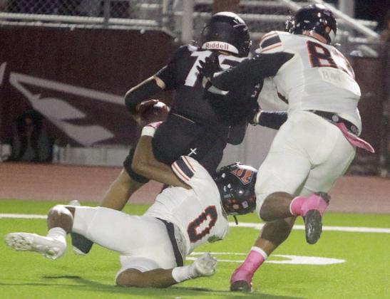 Jakele Houston (No. 0) wraps up Ganado quarterback Landyn Arriaga for a sack in the second quarter with teammate Jayvan Luhrs closing in. Sticker Photo By Darrell Vyvjala