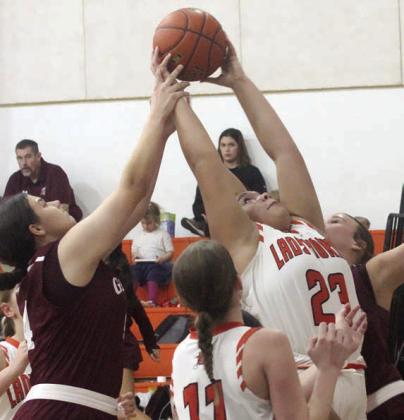 Arianna Vincent pulls down an offensive rebound against Ganado in the second half. Sticker Photo By Darrell Vyvjala