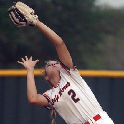 First baseman Audrey Woytek gathers in a Maiden popup. Sticker Photo By Darrell Vyvjala
