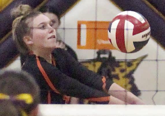 Avery Helms saves a tipped ball near the net in game three on Friday. Sticker Photo By Darrell Vyvjala