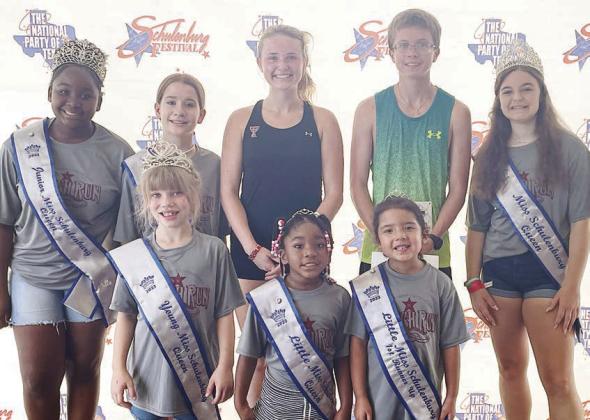 Overall 5K winners – Taylor Limbaugh (back, center) of Lubbock, fastest female; and Nathan Sandelovic (back, second from right) of Hallettsville, fastest male. Also pictured are Miss Schuleburg and her court. Limbaugh also received the “farthest traveled” award. Sticker Photo By Darrell Vyvjala