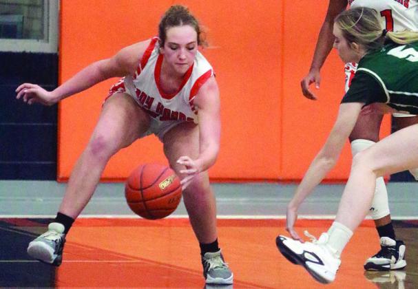 Grace Schramek knocks the ball away from a Lady Eagle in the second half of the Lady Horns’ win over Luling Friday. Sticker Photo By Darrell Vyvjala
