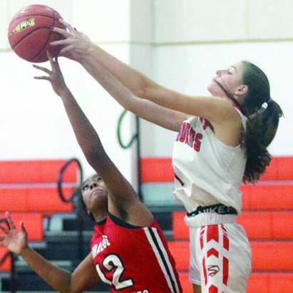 Emmrie Marx leaps over a Cougarette to go for a rebound. Sticker Photo By Darrell Vyvjala