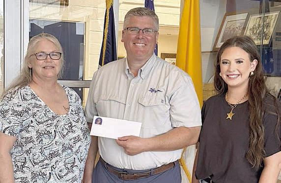 A donation from Sacred Heart Catholic School in Hallettsville was recently presented to Carmen Stoner (left) and Annie Stoner (right) by assistant principal Mike Lemonds (center). Appreciation is extended to all who donated to help the Stoner family recover after their home was damaged by fire.