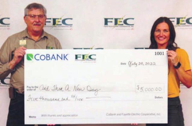And Then a New Day receiving its $5,000 grant. Shown are (from left) Fayette Electric Cooperative General Manager Gary Don Nietsche; and Erin Wotipka, And Then a New Day executive director.