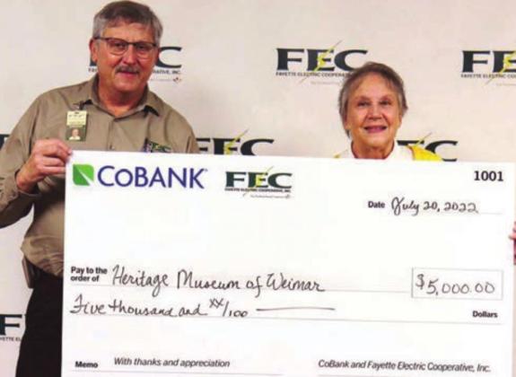 Heritage Society Museum of Weimar receiving its $5,000 grant. Shown are (from left) Fayette Electric Cooperative General Manager Gary Don Nietsche; and Pat Chesser, Heritage Society of Weimar president.