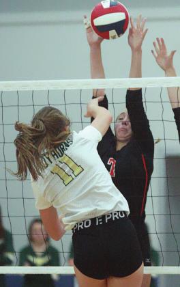 Kloe Kutac goes up for a block in the third set. Sticker Photo By Darrell Vyvjala