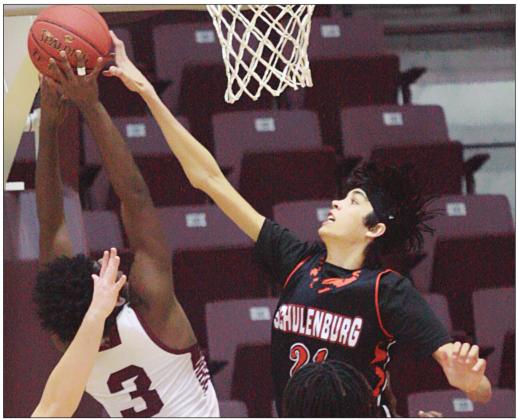 Alex Lozano goes up to reject a Cadarian Wiley shot in the third quarter. Sticker Photo By Kade Vyvjala