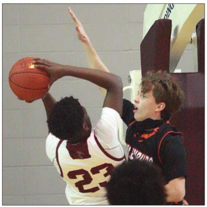 Kenny Schramek defends Omarian Wiley’s shot attempt in the first half. Sticker Photo By Kade Vyvjala