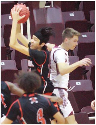 Alex Lozano rips down a defensive rebound over Riley Murchison in the fourth quarter. 	Sticker Photo By Kade Vyvjala