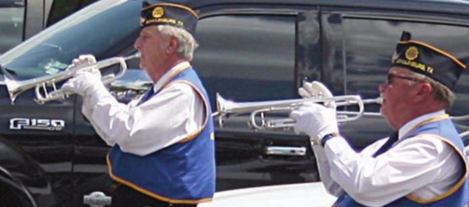 Dennis Olsovsly (left) and Johnny Barton combine on the playing of “Taps.” Sticker Photo By Darrell Vyvjala
