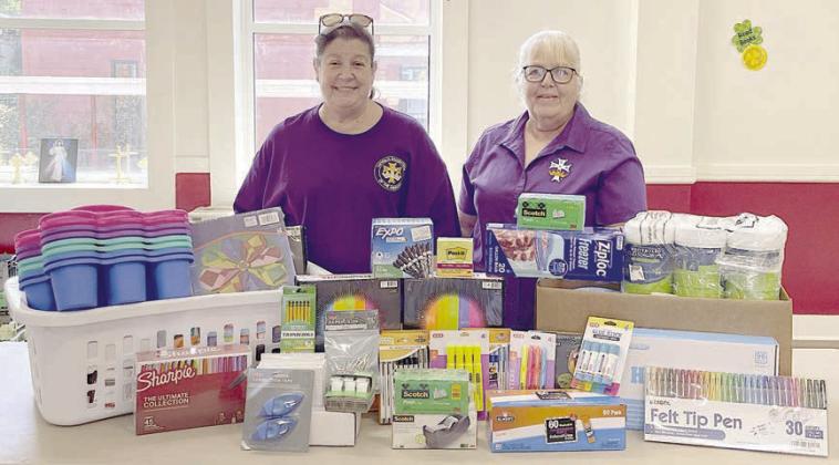 CDA Court St. Rose 1597 regent Grace Lebeda (left) and recording secretary Phyllis Valchar (right) with the school supplies donated to St. Rose of Lima Catholic School.
