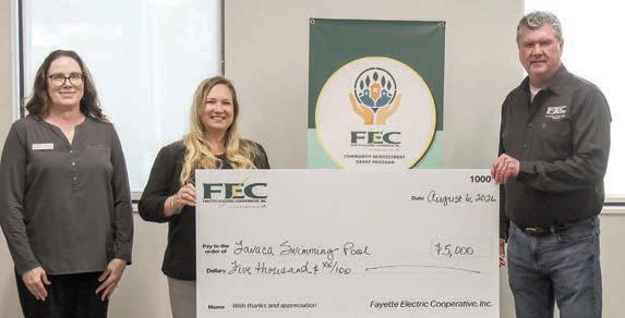 A $5,000 Community Reinvestment Gra nt has been awarded by Fayette Electric Cooperative to Lavaca Swimming Pool Inc. Shown are (from left) Tracy Denton, FEC director of marketing, communications and training; Jennifer Hagan, executive director of the Hallettsville Chamber of Commerce andAgriculture/ Visitor Center; and James Kielty, FEC accounting and finance manager/CFO.