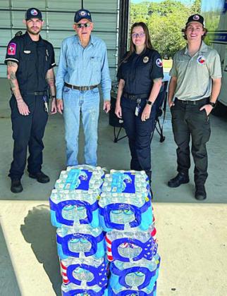 200 pounds of water was donated to the EMS station. Shown are (from left ) Justin Laslie, EMS worker; Ken Berger, SAFP volunteer; Taylor Spackman and Kyler Howeth, EMS workers.