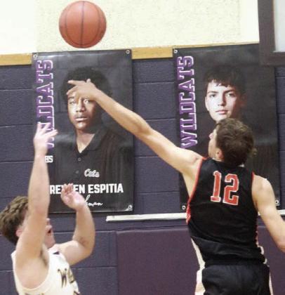 Van Prihoda blocks a Wildcat shot at the end of regulation to send Friday’s game into overtime. Sticker Photo By Darrell Vyvjala
