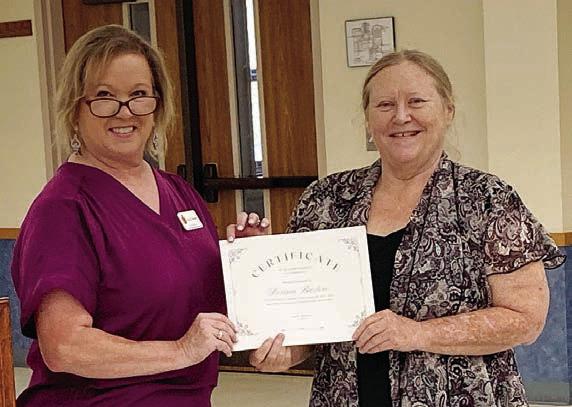 Volunteer of the Year Award for the Fayette County Retired Teachers Association went to Donna Burton (right), with the presentation made by FCRTA president Lisa Slinkard (left).