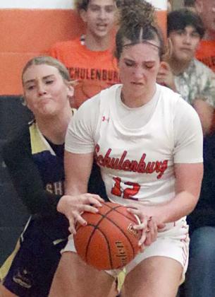 Grace Schramek steps in front of a Lady Comanche for a steal in the second quarter. Sticker Photo By Darrell Vyvjala