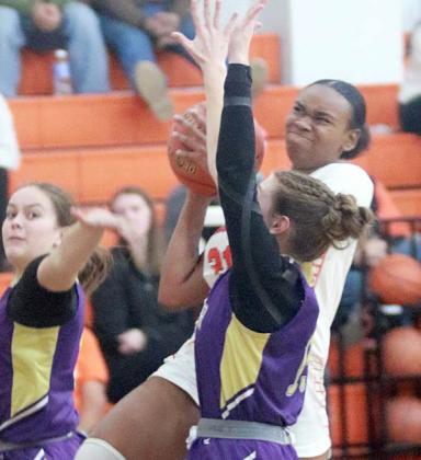 Jashiya Jackson draws a foul on a third-quarter drive Saturday night. Sticker Photo By Darrell Vyvjala