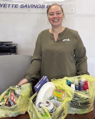 Dona ting bingo prizes to Senior Connections was Brandi Rerich of Fayette Savings Bank.