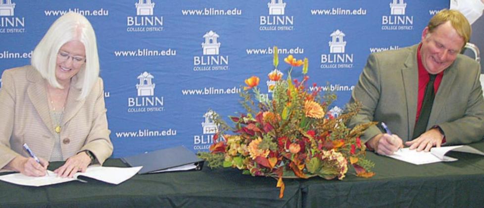 Blinn College District Chancellor Dr. Mary Hensley (left) and Schulenburg ISD Superintendent Duane Limbaugh, who also serves as president of the newly-created Alliance, sign the paperwork for the educational initiative during last Thursday’s ceremony at the Schulenburg campus of Blinn College. Sticker Photo By Darrell Vyvjala