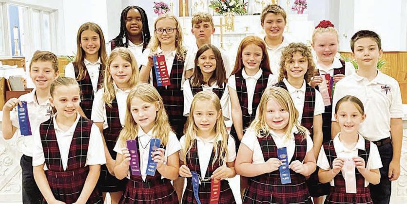 Grades 1-4 Winners – (front row, from left) Addison Johnson, Emileigh Divin, Ellie Klein, Claire McCourt, Ree Lichnovsky, (middle row) Brody Lewis, Brylee Stoever, Emma Zweschper, Rowan Heinrich, Lane Schiffli, Micah Garcia, (back row) Brielle Goedrich, Jade Williams, Penelope Bartek, Jack Schiffli, Noah Heger and Abigale McBride.