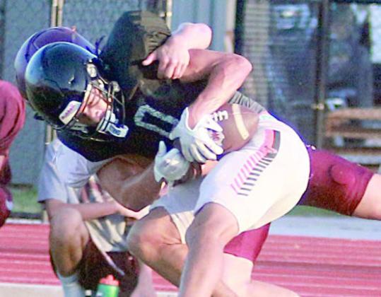 Denver Carr hangs on to the ball for a first-down reception despite the effort of a Ganado defender. Sticker Photo By Darrell Vyvjala