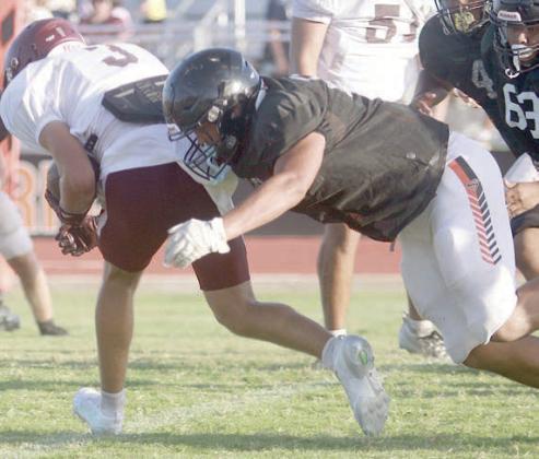 Trey Silcox wraps up a Ganado wide receiver to thwart a screen play. Sticker Photo By Darrell Vyvjala